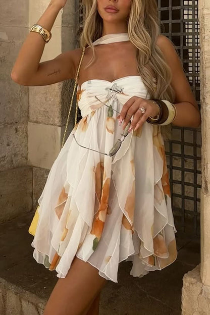 Vestido corto Arabella con volantes, abertura y cuello halter invertido, estampado floral y broche de estrellas de mar 